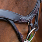 Close-up of the white decorative fancy stitching on a brown EcoRider anatomic leather noseband, showing the padded comfort lining.