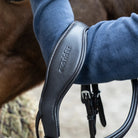 Close-up of an EcoRider anatomical leather headpiece, highlighting the debossed brand logo and thick comfort padding.